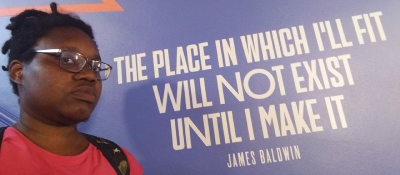 LiLi, defiant, next to a James Baldwin quote: "The place in which I'll fit will not exist until I make it."