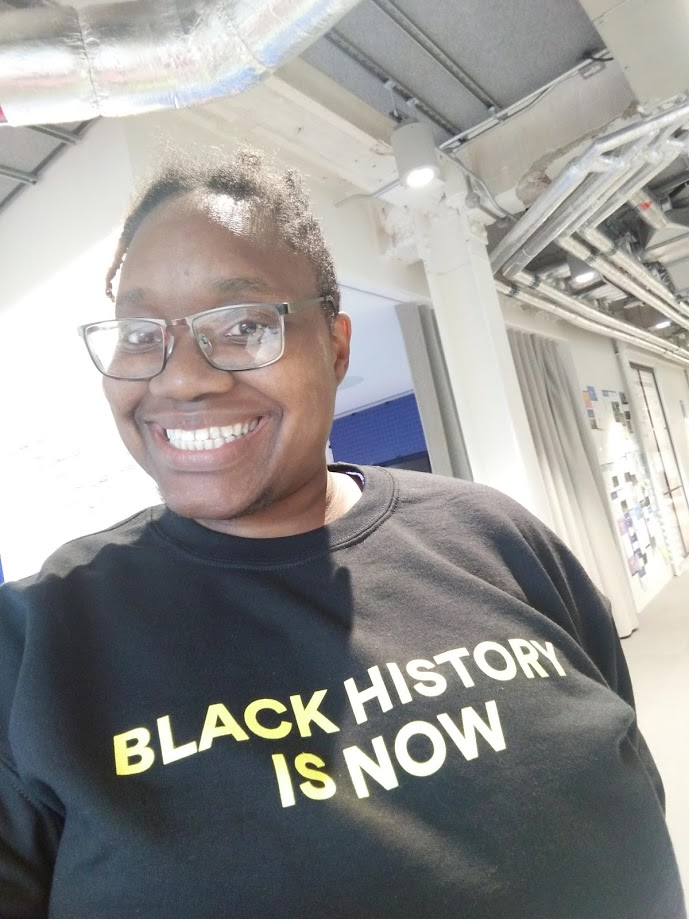 LiLi smiling in a black history is now jumper