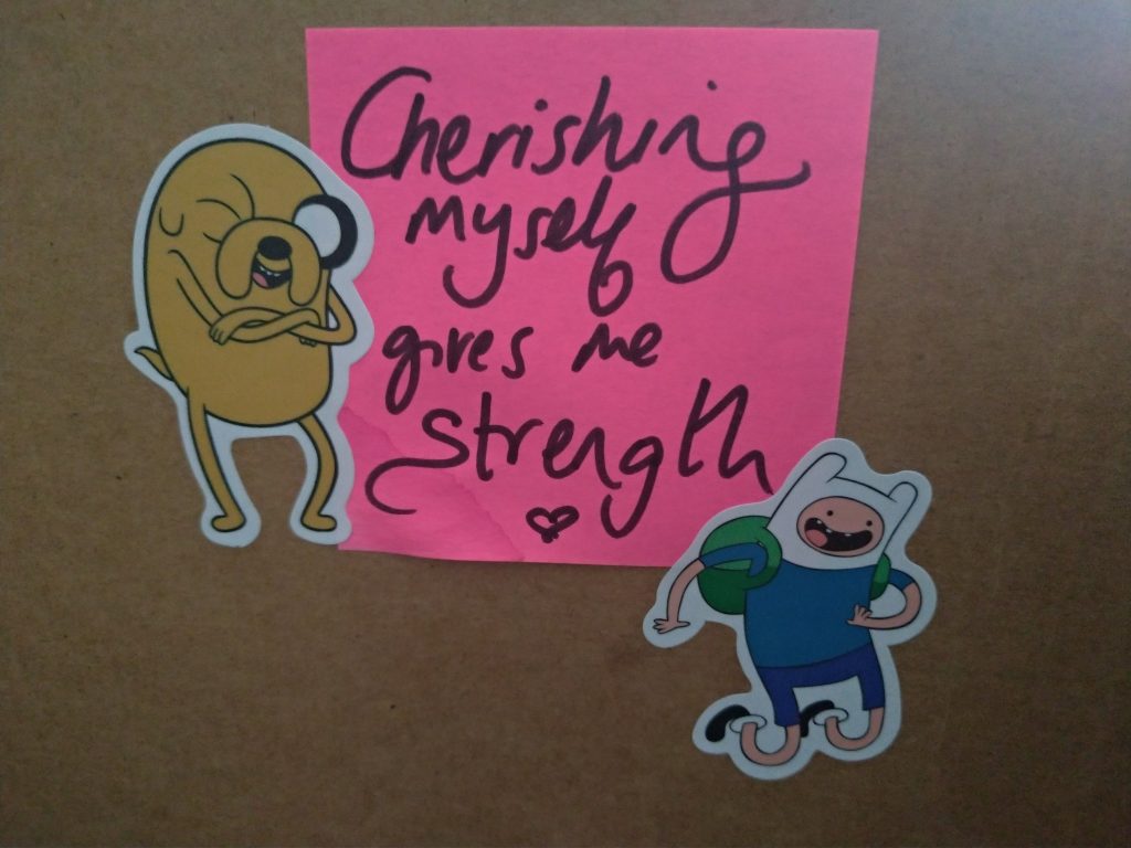 Cherishing myself gives me strength. Adorned with cartoon stickers from 'Adventure Time' of Finn the dog and Jake the human